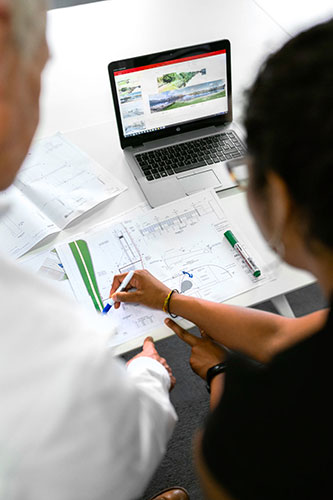 deux personnes travaillant sur un plan technique